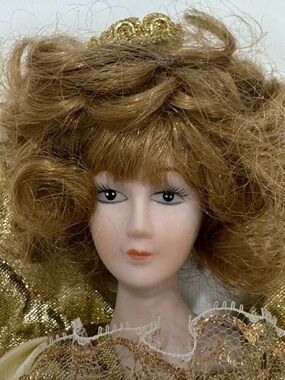 Old Fashioned porcelain and gold fabric tree topper. Plus gold floral